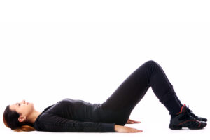Pelvic tilts involve gently moving the pelvis while lying down.